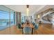 Dining room with a spiral staircase, modern lighting, and stunning waterfront views through large windows at 280 Golden Gate Pt # 400, Sarasota, FL 34236