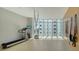 Bright exercise room featuring modern equipment and large windows allowing ample natural light and courtyard views at 280 Golden Gate Pt # 400, Sarasota, FL 34236