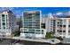 Exterior shot of a waterfront condo building with a pool and dock at 280 Golden Gate Pt # 400, Sarasota, FL 34236