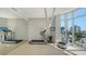 Home gym featuring a treadmill, weight rack, mirror, and a view at 280 Golden Gate Pt # 400, Sarasota, FL 34236