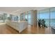Modern kitchen with marble island, hardwood floors, and view of the water at 280 Golden Gate Pt # 400, Sarasota, FL 34236