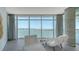 Bright living room featuring neutral decor and picturesque waterfront views through expansive floor-to-ceiling windows at 280 Golden Gate Pt # 400, Sarasota, FL 34236