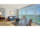 Stylish living room featuring a large window with views, a blue sofa, and elegant decor at 280 Golden Gate Pt # 400, Sarasota, FL 34236