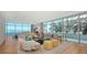 Bright and airy living room with floor-to-ceiling windows offering stunning water views and modern furnishings at 280 Golden Gate Pt # 400, Sarasota, FL 34236