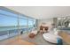 Bright living room featuring floor-to-ceiling windows with waterfront views and modern decor at 280 Golden Gate Pt # 400, Sarasota, FL 34236