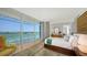Well-lit main bedroom with large windows, water view, and a comfortable bed at 280 Golden Gate Pt # 400, Sarasota, FL 34236