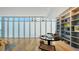 Bright office with modern finishes, large built-in bookshelf, and ample light from large windows at 280 Golden Gate Pt # 400, Sarasota, FL 34236