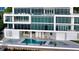 Luxury condo building with pool and multiple lounge chairs on the waterfront at 280 Golden Gate Pt # 400, Sarasota, FL 34236
