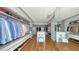 Organized walk-in closet with custom shelving, mirrored doors, and seating provides ample storage space at 280 Golden Gate Pt # 400, Sarasota, FL 34236