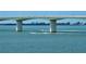 Bridge spanning Sarasota Bay over sparkling water with boat traffic and lush coastline in the distance at 280 Golden Gate Pt # 400, Sarasota, FL 34236