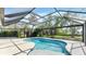 Inviting swimming pool with screened enclosure offering an ideal outdoor leisure and entertaining space at 316 Scott Ave, Sarasota, FL 34243