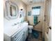Well-lit bathroom featuring modern fixtures, a decorative mirror, and ample counter space at 3335 Spanish Oak Ter, Sarasota, FL 34237