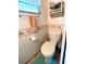 Functional bathroom featuring a toilet, seashell decor and neutral colored walls at 3335 Spanish Oak Ter, Sarasota, FL 34237