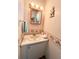 Functional bathroom with a single sink vanity, warm lighting, and nautical accents at 3335 Spanish Oak Ter, Sarasota, FL 34237