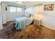 Bright bedroom featuring neutral walls, a twin bed with a light blue quilt, and complementary decor at 3335 Spanish Oak Ter, Sarasota, FL 34237