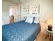 Cozy bedroom with built-in shelving, carpet floors, and a view to the dining room at 3335 Spanish Oak Ter, Sarasota, FL 34237