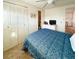Relaxing bedroom featuring a ceiling fan, closet, and a view to the bathroom at 3335 Spanish Oak Ter, Sarasota, FL 34237