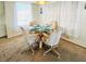 Cozy dining area with glass table and seating for four at 3335 Spanish Oak Ter, Sarasota, FL 34237