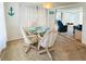 Cozy dining area with glass table and seating for four at 3335 Spanish Oak Ter, Sarasota, FL 34237