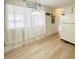 Dining room features white curtains and light wood flooring at 3335 Spanish Oak Ter, Sarasota, FL 34237