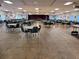 Large community event space furnished with round tables and chairs at 3335 Spanish Oak Ter, Sarasota, FL 34237