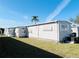 Neat home exterior showcasing a well-kept lawn and a peaceful neighborhood setting at 3335 Spanish Oak Ter, Sarasota, FL 34237