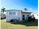 Charming home exterior with an air conditioning unit and a well-maintained lawn at 3335 Spanish Oak Ter, Sarasota, FL 34237