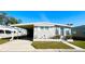 Charming single-story home featuring a covered parking area and well-maintained front lawn at 3335 Spanish Oak Ter, Sarasota, FL 34237