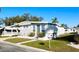 Cozy single-story home with a carport, neat landscaping, and a sunny, inviting facade at 3335 Spanish Oak Ter, Sarasota, FL 34237