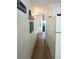 Long hallway with durable flooring, neutral paint and easy access to the kitchen at 3335 Spanish Oak Ter, Sarasota, FL 34237