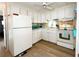 Bright kitchen features white cabinets, modern appliances and a window over the sink at 3335 Spanish Oak Ter, Sarasota, FL 34237