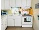 Bright kitchen features white cabinets, modern appliances and a window over the sink at 3335 Spanish Oak Ter, Sarasota, FL 34237