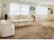 Inviting living room with a ceiling fan, bright windows, and comfortable seating arrangements at 3335 Spanish Oak Ter, Sarasota, FL 34237