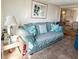 Cozy living room featuring a comfortable sofa, nautical decor and ample natural light at 3335 Spanish Oak Ter, Sarasota, FL 34237