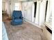 Relaxing living room featuring a comfy armchair, carpet floors and bright windows at 3335 Spanish Oak Ter, Sarasota, FL 34237