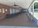 Covered patio area with picnic tables and rocking chairs for community gatherings at 3335 Spanish Oak Ter, Sarasota, FL 34237