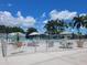 Beautiful pool area with lush landscaping, palm trees, and comfortable seating for relaxation and enjoyment at 3335 Spanish Oak Ter, Sarasota, FL 34237