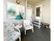 Inviting porch area featuring comfortable seating, a charming side table, and a welcoming entrance at 3335 Spanish Oak Ter, Sarasota, FL 34237