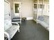 Covered porch with seating, a small table, and a serene spot to enjoy the outdoors at 3335 Spanish Oak Ter, Sarasota, FL 34237