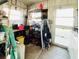 Practical storage area with shelving, a workbench, and natural light from the door and windows at 3335 Spanish Oak Ter, Sarasota, FL 34237