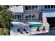 Aerial view of the patio with a pool, an outdoor kitchen, and outdoor seating at 3540 Mistletoe Ln, Longboat Key, FL 34228