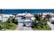 Aerial view of a luxury home with a paver driveway, three-car garage, and manicured landscaping at 3540 Mistletoe Ln, Longboat Key, FL 34228