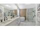 Bright bathroom with a double vanity, a soaking tub, a glass-enclosed shower, and modern fixtures at 3540 Mistletoe Ln, Longboat Key, FL 34228