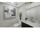 Well-lit powder room showcasing stylish vanity, modern fixtures, and decorative wall art at 3540 Mistletoe Ln, Longboat Key, FL 34228