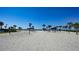 Sandy beach with clear blue sky featuring beach volleyball and covered picnic seating at 3540 Mistletoe Ln, Longboat Key, FL 34228