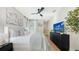 A bright bedroom with neutral decor, a ceiling fan, and a flat screen television on a dresser at 3540 Mistletoe Ln, Longboat Key, FL 34228