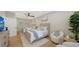Guest bedroom featuring twin beds, soft blue accents, stylish seating, and natural light at 3540 Mistletoe Ln, Longboat Key, FL 34228