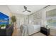 A bedroom with a ceiling fan, light walls, light decor, and a flat screen television at 3540 Mistletoe Ln, Longboat Key, FL 34228