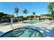 Community pool area features a hot tub, lush landscaping, and lounge chairs for relaxation at 3540 Mistletoe Ln, Longboat Key, FL 34228