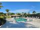 Community pool area with lounge chairs, a covered seating area, and lush landscaping at 3540 Mistletoe Ln, Longboat Key, FL 34228